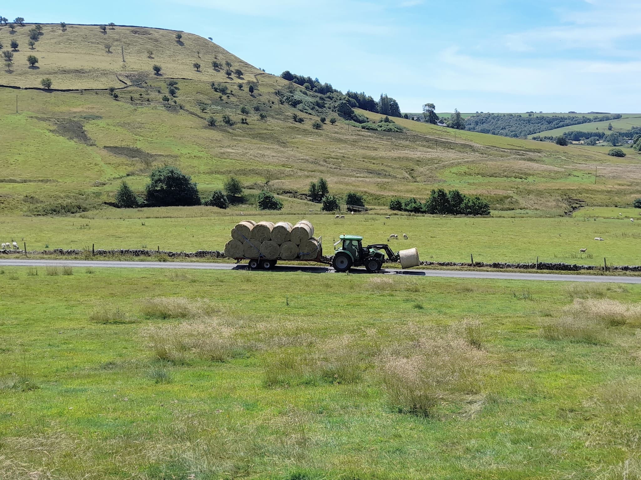 Tractor with trailer loaded with straw bales